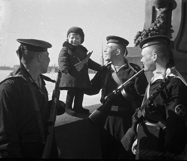 Soviet Baltic Fleet sailors with orphan Lucy, Leningrad, Russia, May 1943
