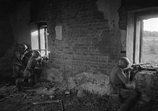 Soviet Senior Sergeant Fominykh, Sergeant Khizmatulin, and another soldier firing from a position inside a wrecked building, Eastern Europe, Oct 1942