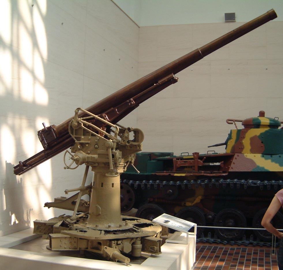 Japanese Type 88 75mm anti-aircraft gun on display at the Yushukan Museum on the grounds of the Yasukuni Shrine, Tokyo, Japan, 6 Aug 2005; note Type 95 Ha-Go tank in background